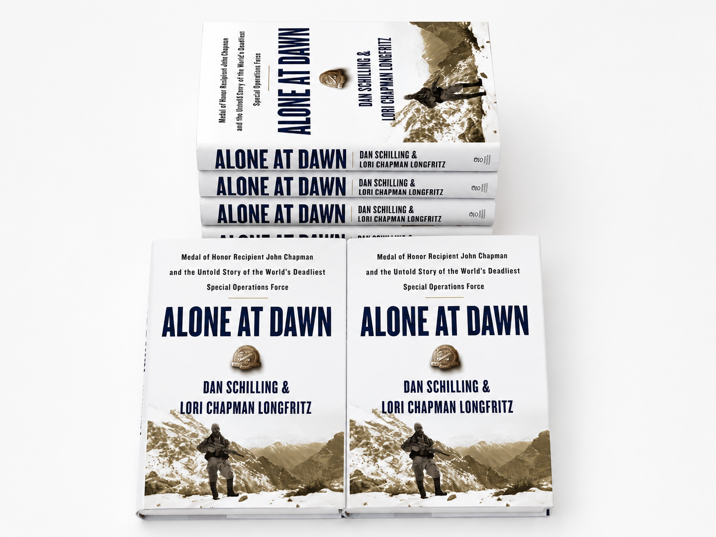 Multiple signed copies of Alone at Dawn by Dan Schilling and Lori Chapman Longfritz displayed in stack arrangement on white background