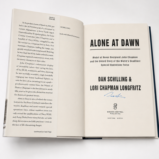 Open signed copy of Alone at Dawn by Dan Schilling and Lori Chapman Longfritz showing title page and signature